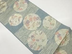  紗 花輪丸文に流水模様織出し袋帯